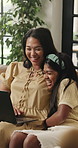 Laptop, smile and relax with mom and girl on sofa for streaming service, movie choice and education show. Film subscription, bonding and online kids series with woman and daughter in family home