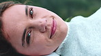Face, relax and happy woman in countryside for holiday, peace and calm on weekend break with wind. Smile, portrait and person rest outdoor in nature for tourism, breeze and vacation in Germany