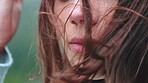 Breeze, hair and hiking with woman outdoor in nature for fresh air, travel or weekend sightseeing. Holiday, vacation and windy with face of hiker person in environment for adventure or explore