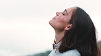 Woman, relax and fresh air outdoor with wind, mindfulness and thinking for inspiration on vacation. Space, female person and zen reflection with breeze, wellness and peace for tranquil holiday.