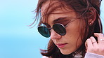 Woman, sunglasses and thinking on vacation with wind, outdoor and reflection on break in nature. Girl, perspective and insight with shades, gen z fashion and tourism for daydream on summer holiday