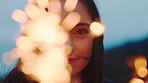 Woman, face and smile at beach with sparklers in evening for celebration, birthday and vacation. Girl, happy and portrait with fireworks, excited or outdoor on getaway with milestone in Portugal