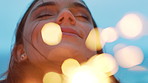 Woman, celebration and happy at beach with sparklers in evening for memory, birthday and vacation. Girl, smile and reflection with fireworks, success and outdoor on getaway with milestone at seaside