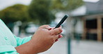 Hands, woman and typing with phone in city for travel, social media and directions on holiday. Female person, reading and mobile for browsing website, navigation and tourist destination on vacation