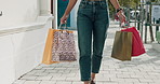 Fashion, woman and walk with shopping bag outdoor for sale, discount and Black Friday promotion. Gift, shopper and person travel in city for retail therapy, hands and happy customer with sunglasses