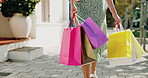 Legs, shopping and spin with woman in sidewalk in city for consumerism, buying or purchase. Bags, turning and walking with customer person outdoor to search for bargain, deal or sale discount