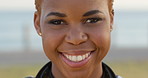 Face, smile and black woman by ocean for vacation with peace, calm or travel in summer. Portrait, holiday and happy person on trip for tourism, getaway and adventure at sea on tropical island
