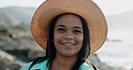 Face, smile and woman by ocean for vacation, travel and getaway with outdoor retreat in nature. Portrait, hat and person at beach for holiday, tourism and summer trip on tropical island  in Brazil