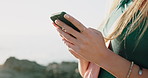 Phone, hands and woman by beach for travel, vacation or getaway with texting on mobile app. Technology, outdoor and female person with cellphone for networking, social media or chatting by ocean.