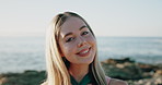 Face, smile and woman at beach for vacation, tourism and adventure with wanderlust on holiday. Portrait, sea and happy person by ocean outdoor for getaway, travel and summer trip in Australia