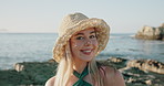 Face, smile and woman at beach for travel, tourism and adventure with wanderlust on holiday. Portrait, hat and happy person by ocean outdoor for getaway, vacation and summer trip in Australia