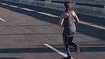 Exercise, woman and running on highway for cardio, wellness and fitness for endurance from back. Workout, agile person or runner in city for training outdoor, health benefits or jog for sports