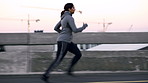 Running, fitness and woman in city, profile and endurance for health benefits, wellness or routine. Outdoor, person or athlete in street, challenge or exercise for cardio workout, training or morning