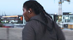 Running, fitness and woman in city, earphones and endurance for health benefits, radio or routine. Audio, person and athlete in street, challenge and exercise for cardio workout, wellness and sound