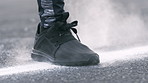 Fitness, chalk and feet of man outdoor with warm up for running, workout or challenge for health. Sports, gym powder and shoes of male person preparing for cardio exercise in road for wellness.