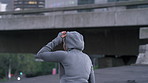 Woman, runner and thinking with fitness in city with break, hoodie and perspective with urban bridge. Person, rest and tired with reflection in street, outdoor or exercise for wellness in town