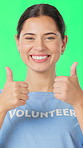 Face, volunteer and woman with thumbs up on green screen for non profit, thank you and smile. Happy person, like sign and NGO worker on background, portrait or support for humanitarian aid in studio
