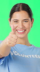 Face, volunteer and happy woman with thumbs up on green screen for non profit, thank you and goal. Charity, person and like sign for NGO, portrait or support for humanitarian aid on studio background