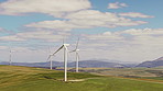 Wind turbine, power or grass field with blue sky for renewable energy or economic development. Windmill, outdoor sustainability or eco friendly environment with  natural alternative resource on space