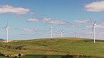 Drone, wind turbine and renewable energy with landscape,  empty and countryside with machine. Outdoor, nature and ecology for power, grass field and environment with carbon footprint and windfarm