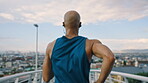 Fitness, back or runner in town with earphones, cardio playlist or stamina exercise in physical activity. Training, jog or male person with tech, sports podcast or endurance workout on bridge.