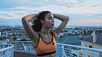 Runner, woman and break in city with breathing, exercise fatigue and endurance training for wellness. Active, female person and fitness on bridge with reflection, sports or workout rest for recovery.