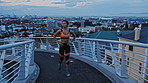 City, athlete and woman with earphones on bridge, breathing and thinking after exercise or wellness. Outdoor, evening and African person with tech for streaming music, cardio and workout for fitness