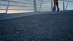 City, feet and running on bridge for fitness, athlete and workout routine for body goals or wellness. Outdoor, runner and person on road for exercise, performance and training for physical health