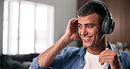 Headphones, singing and man with dancing in home, streaming music playlist and radio song for break. Audio tech, album and happy person listening to track in apartment, groove and moving to rhythm