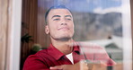 Breathing, smile or man at window with thinking, perspective or nostalgia on weekend break. Happy, mindfulness or male person in house with thoughts, positive memory or daydreaming in free time.