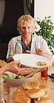 Patio, man and lunch with friends at house for social gathering, chat or group with food for reunion. Home, together and hangout with meal on weekend, happy and people with alcohol for outdoor event