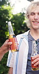Cheers, friends and men with beer in backyard for social gathering, party and hangout together. Garden, toast and people with drinks outdoor for barbecue for holiday, vacation and reunion on weekend
