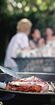 Backyard, barbecue and people with meat on grill for social gathering, party and hangout together in summer. Fire, cookout and steak with flames for bbq for holiday, celebrate and reunion on weekend
