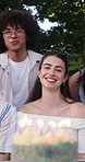 Face, friends and singing with cake at backyard for birthday, event and people with smile for party. Group, together and outdoor for social gathering with dessert, home and celebration with song