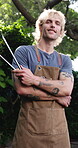 Happy, face and man with tongs for bbq, host and getting ready for outdoor event or culinary skills. Backyard, portrait and person with arms crossed on holiday, home and smile with grilling equipment