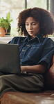 Business, woman and typing on laptop in home for news article, editing submission and remote work. Freelance journalist, african person and tech on sofa for blog post, online research and publication