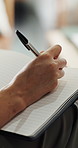 Diary, writing and hands of person in home for wellness, mental health and reflection. Notebook, pen and journal with feelings for self care with agenda planning, schedule or to do list in house.