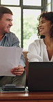 Discussion, paper and interracial couple in home with laptop, finance review and online banking on sofa. Budget, man and woman with tech, investment document and planning in asset management.