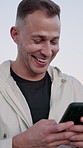 Fitness, laugh and man with smartphone outdoor for meme, social media or reading notification. Sports, mobile and funny person in nature with text message, joke or online chat for communication