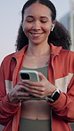 Fitness, mobile and woman with earphones in city, streaming service and social media notification. Phone, sports and happy person outdoor with audio, walking and online search for music playlist