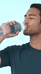 Man, fitness and drinking with water bottle in studio for hydration on a white background. Active, male person or aqua beverage with mineral liquid for workout recovery, exercise break or rest
