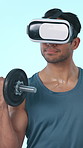 Muscles, weights and man with virtual reality in studio for bodybuilder, exercise or metaverse. Health, fitness and person with vr headset for weightlifting, workout or digital gym on blue background