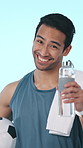 Towel, soccer and face of man in studio with ball for active hobby, training and recovery for practice. Sports, happy and portrait of person with water, exercise and competition on blue background