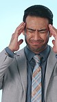 Employee, pain and man with headache in studio, wealth manager and stress for stock market or worry. Blue background, anxiety and person with migraine for financial crisis, frustrated and reflection