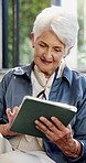 Senior, woman and tablet in home for reading email, check article or ebook on weekend in retirement. Technology, smile and elderly person in living room for online news, scroll blog or relax with app
