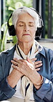 Headphones, meditation and relax with old woman on sofa in home for peace, breathing and sound. Zen music, spiritual connection and holistic subscription with senior person in house for yoga audio