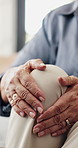 Hands, knee pain and injury in nursing home with fatigue, arthritis or muscle sprain on lounge sofa. Elderly person, joint ache and fibromyalgia for inflammation, strain or tension in retirement