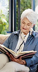Old woman, relax and reading on sofa with book in home with with story, literature and poetry in retirement. Elderly person, information and chill with novel, fiction and learning in lounge at house