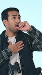 Coughing, backpacker and man with sickness on holiday, adventure and travel with allergies in studio. Blue background, backpacking and person with flu on vacation, illness and hiker with infection