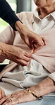 Dressing, old woman and caregiver in home, hands and patient with Alzheimer, retirement and support. Assisted living, nurse and help with clothes, wellness and elderly person with dementia in house